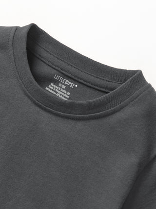 Little Bipsy Elevated Tee - Shadow
Close-up of a dark gray sweatshirt with 'LITTLE RIPSY' branding on the collar.