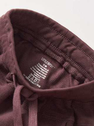 Little Bipsy Waffle Jogger - Huckleberry
Close-up of a brown garment with a Littlebipsy label on a light gray background
