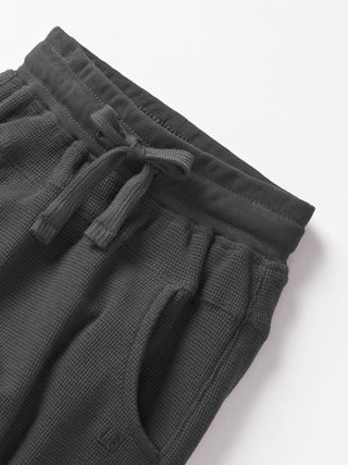 Little Bipsy Waffle Jogger - Shadow
Dark gray waffle knit shorts with drawstring on a white background