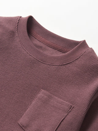 Little Bipsy Waffle Top - Huckleberry
Close-up of a textured purple shirt with a pocket on a white background