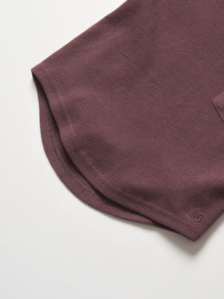 Little Bipsy Waffle Top - Huckleberry
Close-up of a brown textured fabric on a white background