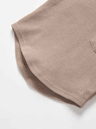 Little Bipsy Waffle Top - Mushroom
Close-up of a brown polo shirt with a brand logo on a white background