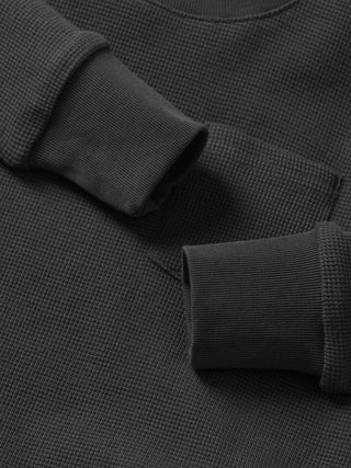 Little Bipsy Waffle Top - Shadow
Close-up of a dark gray textured sweater with rolled-up sleeves.