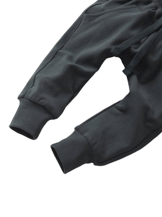 Little Bipsy Jogger - Shadow
Dark gray sweatpants on a light gray background