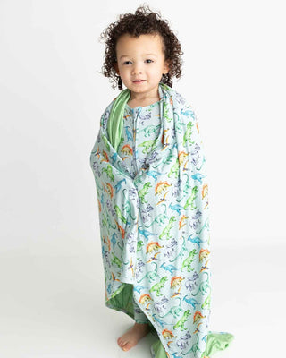 Lev Baby Blanket - Landon
Child wrapped in a dinosaur-patterned blanket on a white background