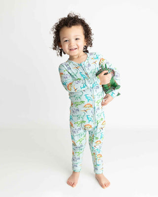 Lev Baby Poppy Convertible Zipper Romper - Landon
Child wearing a dinosaur-themed onesie holding a toy on a white background