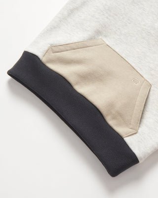 Little Bipsy Colorblock Mockneck Pullover - Stone Grey
Folded black, beige, and white fabric on a light gray background