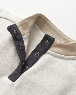 Little Bipsy Colorblock Mockneck Pullover - Stone Grey
Close-up of a garment with black shoulder straps and beige collar on a light background