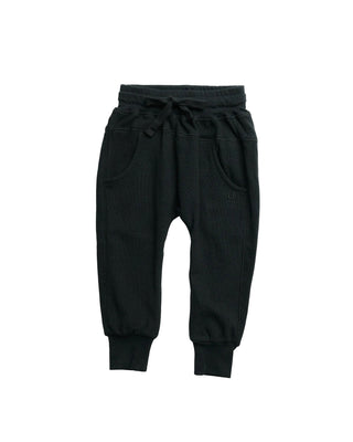 Little Bipsy Waffle Joggers - Black
Black jogger-style pants with an elastic drawstring waist, side pockets, and ribbed cuffs, shown flat on a white background.