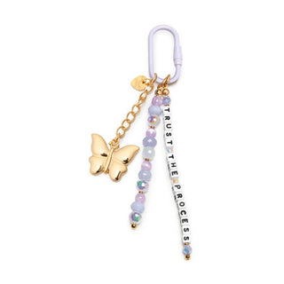 Little Words Project Bag Charm - Trust the Process
A pastel beaded keychain with a white carabiner, gold butterfly charm, and a vertical bead strand spelling 'TRUST THE PROCESS' on a white background.