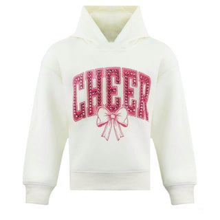 Lola and The Boys Crystal Cheer Bow Sweatshirt
An off-white pullover hoodie featuring a pink graphic on the front with the word 'CHEER' in arched letters outlined with small dots, and a bow illustration underneath.