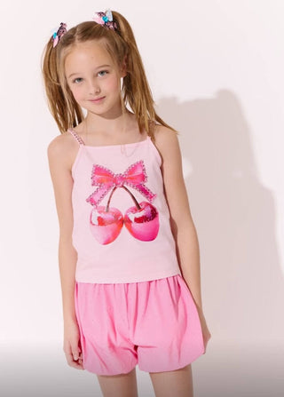 Lola and The Boys Disco Cherry Tank Top
Young girl wearing a pink outfit with a bow design on a white background