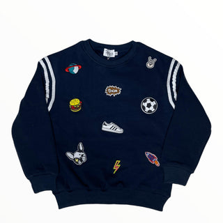 Lola and The Boys Varsity Patch Jogger Set - Navy
Navy blue sweatshirt with various colorful patches on a white background