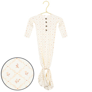 Lou Lou and Company Knotted Gown - Annie
Baby onesie with floral pattern on a hanger against a white background