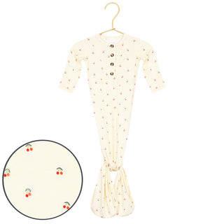 Lou Lou and Company Knotted Gown - Sadie
A cream-colored baby footed sleeper with a small cherry print, shown on a gold hanger with a circular inset detail of the cherry pattern.