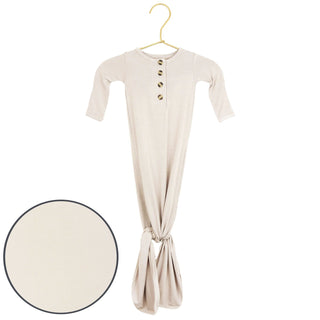 Lou Lou and Company Knotted Gown - Winnie
Beige dress with button details on a hanger against a white background