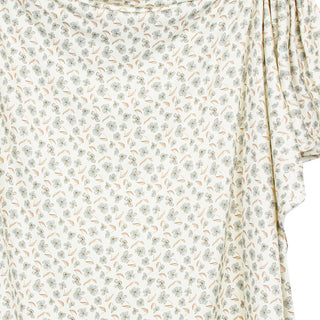 Lou Lou and Company Swaddle Blanket - Faye
A close-up of a draped fabric with a delicate, small-scale floral and leaf pattern 
in muted sage green, light blue, and tan on an off-white background.