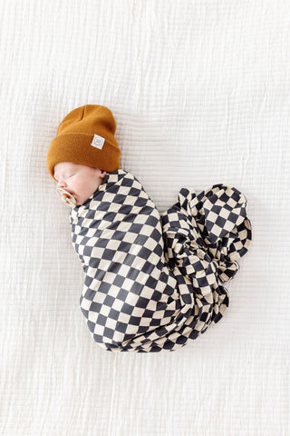 Lou Lou and Company Swaddle Blanket - Gibson
Newborn baby swaddled in a checkered blanket with a mustard yellow beanie on a white background