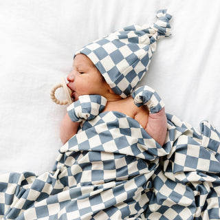 Lou Lou and Company Swaddle Blanket - Miles
Newborn baby wrapped in a blue and white checkered blanket with matching hat on a white background