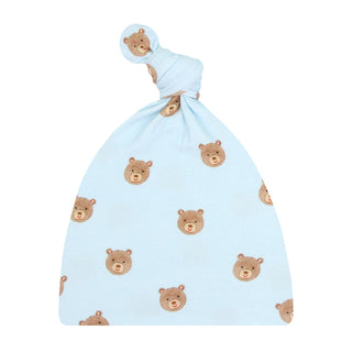 Lou Lou and Company Top Knot Hat - Theodore
A baby soft fabric bottle cap cover in light blue with a repeating pattern of brown teddy bear faces, shown with a matching knotted cap on a plain white background.