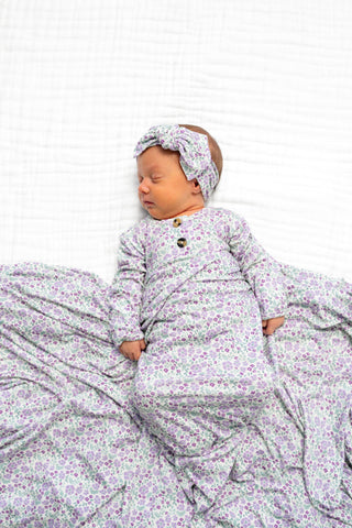 Lou Lou and Company Top and Bottoms - Lily Newborn baby in a floral outfit and headband on a white background