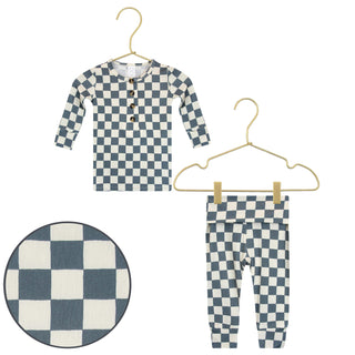 Lou Lou and Company Top and Bottoms - Miles
Children's checkered shirt and pants set on hangers with a close-up of the fabric pattern.