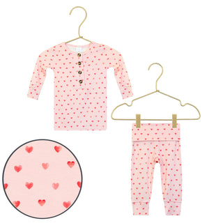 Lou Lou and Company Top and Bottoms - Miley
Pink children's outfit with heart pattern on hangers against a white background