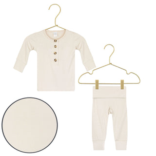 Lou Lou and Company Top and Bottoms - Winnie
Beige baby shirt and pants set on hangers with a close-up of the fabric texture.