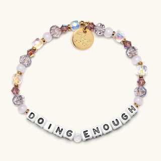 Little Words Project bracelet with "Doing Enough" word charm, stylish accessory in a close-up shot.