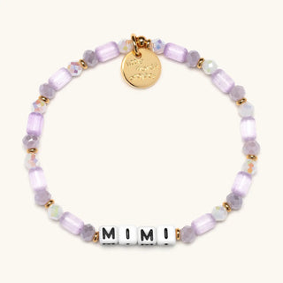 Little Words Project Mimi bracelet featuring delicate gold chain and engraved word charm on a neutral background.