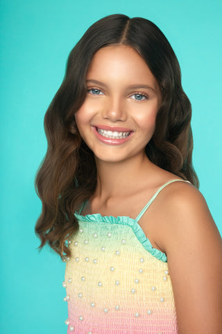 MIA New York Smocked Pearl Embellished Dress - Rainbow
Young girl with long brown hair wearing a colorful dress against a turquoise background