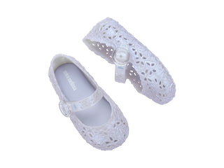 Mini Melissa Pollen - Pearly Blue
White lace shoes with a bow on a white background