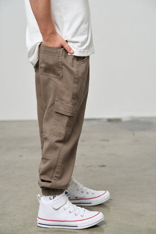 Little Bipsy Cotton Twill Cargo Jogger - Mushroom
Person wearing brown cargo pants and white sneakers on a plain background