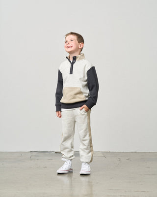 Little Bipsy Side Stripe Jogger - Stone Grey
Child wearing a two-tone fleece pullover and pants against a plain background