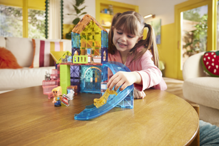 Magna-Tiles Pet Playhouse™ 50-Piece Set
Child playing with colorful building blocks on a table in a bright room.
