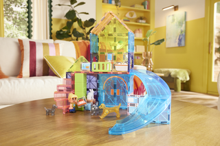 Magna-Tiles Pet Playhouse™ 50-Piece Set
Colorful toy house with a slide on a wooden table in a bright room.