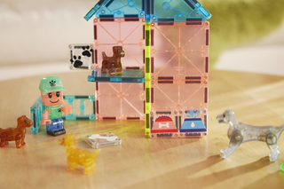 Magna-Tiles Puppy Park™ 27-Piece Set
Toy building set with transparent blocks and small figures on a wooden surface