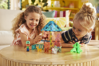 Magna-Tiles Puppy Park™ 27-Piece Set
Two children playing with colorful building blocks on a wooden table.