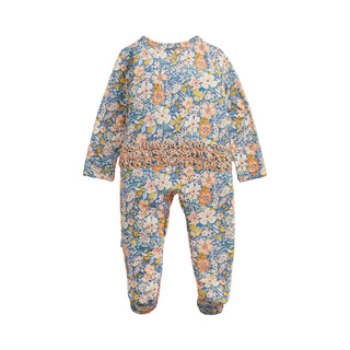 Magnetic Me Modal Footie with Ruffle - Flora
A baby footed one-piece jumpsuit with a blue floral print and a smocked waist, shown flat on a light gray background.