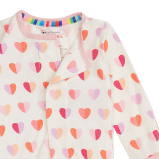 Magnetic Me Modal Magnetic Footie - Pink XOXO
Baby onesie with colorful heart pattern on a white background