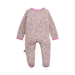 Magnetic Me Modal Magnetic Footie - Stella
A baby long-sleeve footed sleeper with a dense multicolor floral print on a light pinkish-white base, featuring solid pink trim at the collar and cuffs.