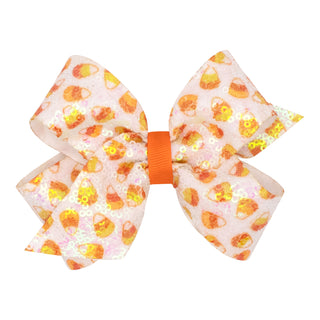 Medium Wee Ones Candy Corn Sequin Hair Bow on Clippie
A large hair bow featuring a candy corn pattern on a light pink sequined fabric, secured with a bright orange elastic band, shown against a plain white background.