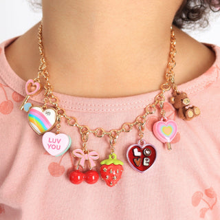 Close-up of Charm It! gold strawberry charm, a detailed jewelry pendant with a shiny gold finish and intricate berry design.