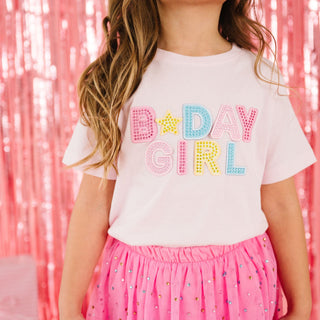 Sweet Wink Birthday Girl Rhinestone Patch Short Sleeve T-ShirtChild wearing a 'B-Day Girl' shirt with a pink background