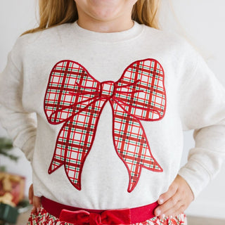 Sweet Wink Christmas Plaid Bow Patch Sweatshirt - Natural
Child wearing a white sweater with a large red plaid bow design.