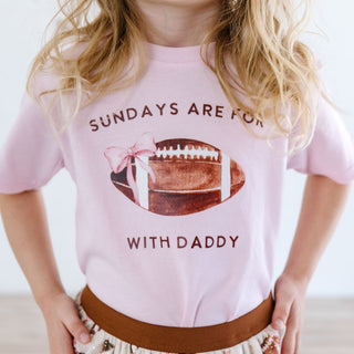 Sweet Wink Football With Daddy Short Sleeve T-Shirt - Ballet Child wearing a pink t-shirt with a football graphic and text.