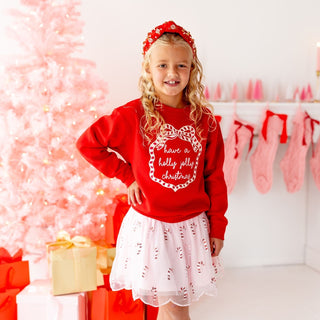 Sweet Wink candy cane scalloped tutu skirt worn by model, featuring festive red and white stripes and playful holiday design.