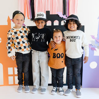 Sweet Wink Boo Drip Halloween Trucker Hat - Black/White Four children in Halloween-themed clothing posing in front of a colorful backdrop with Halloween decorations.