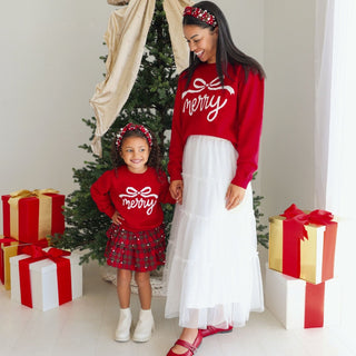 Sweet Wink Merry Bow Christmas women's sweater worn by model, featuring festive design with pearls and holiday style.