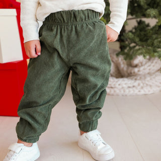 Model wearing Sweet Wink Forest Corduroy Jogger in a casual outdoor setting, showcasing the comfortable, textured fabric.